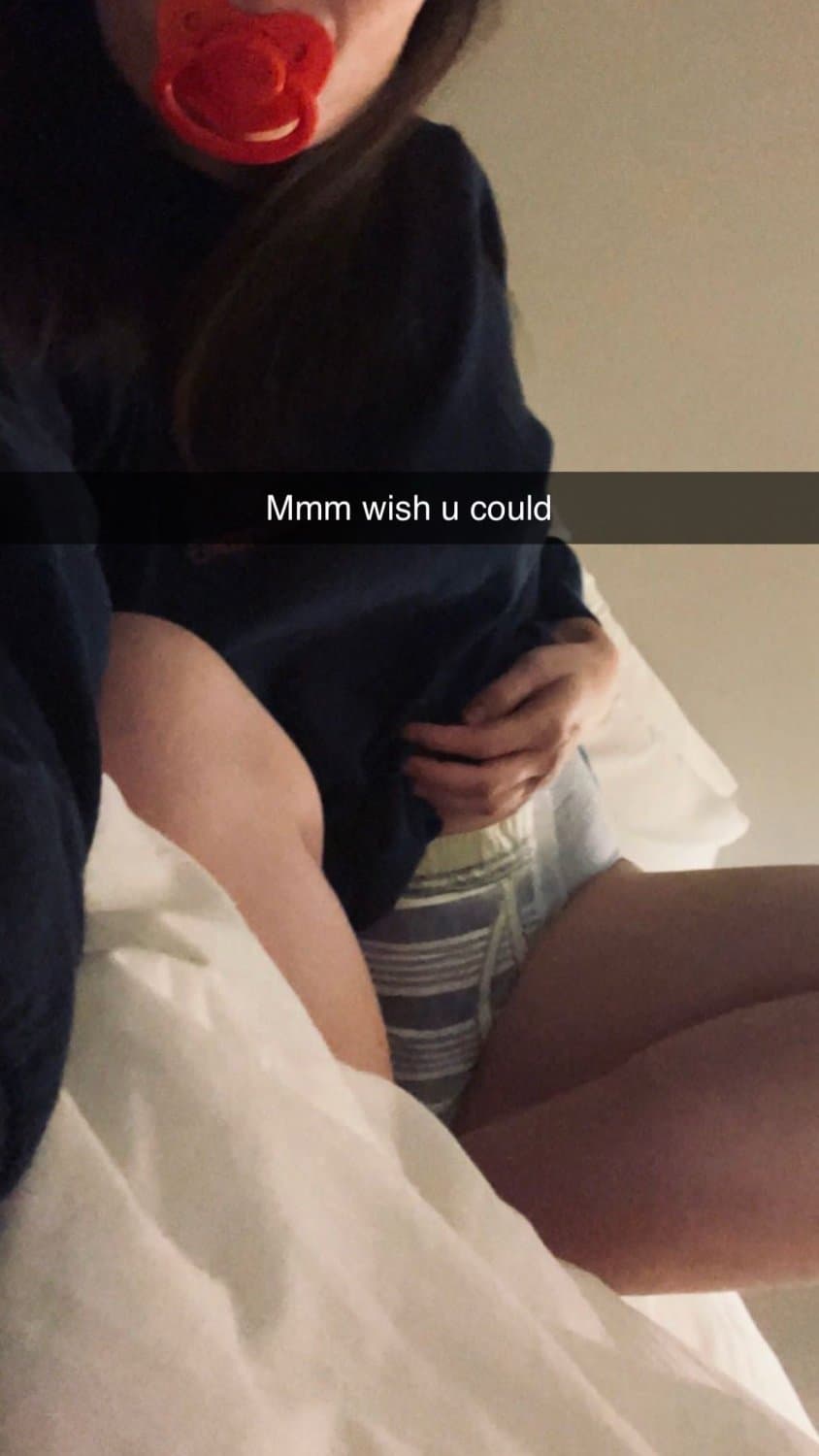 Cute tanned girl shows off her diapers and pull-ups