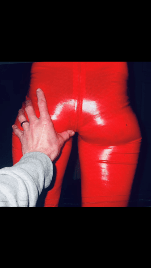 English petite biker milf in red pvc catsuit strips naked again tattoos and pierced nipples