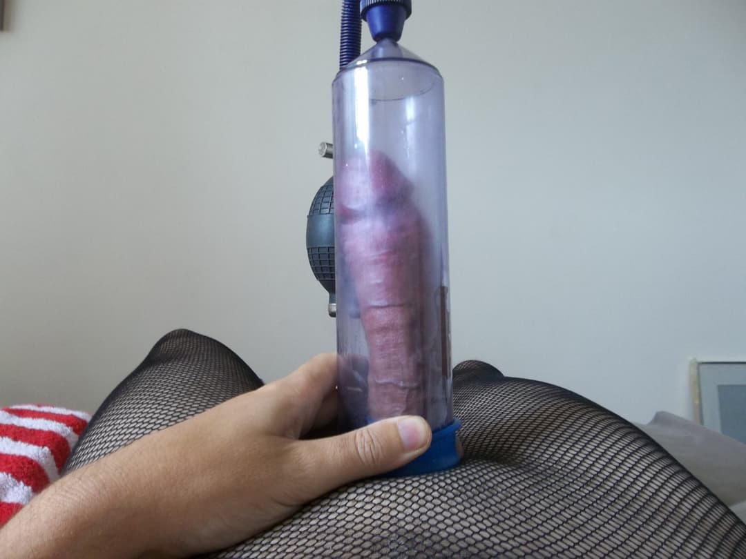 cross dresser playing with a cock pump