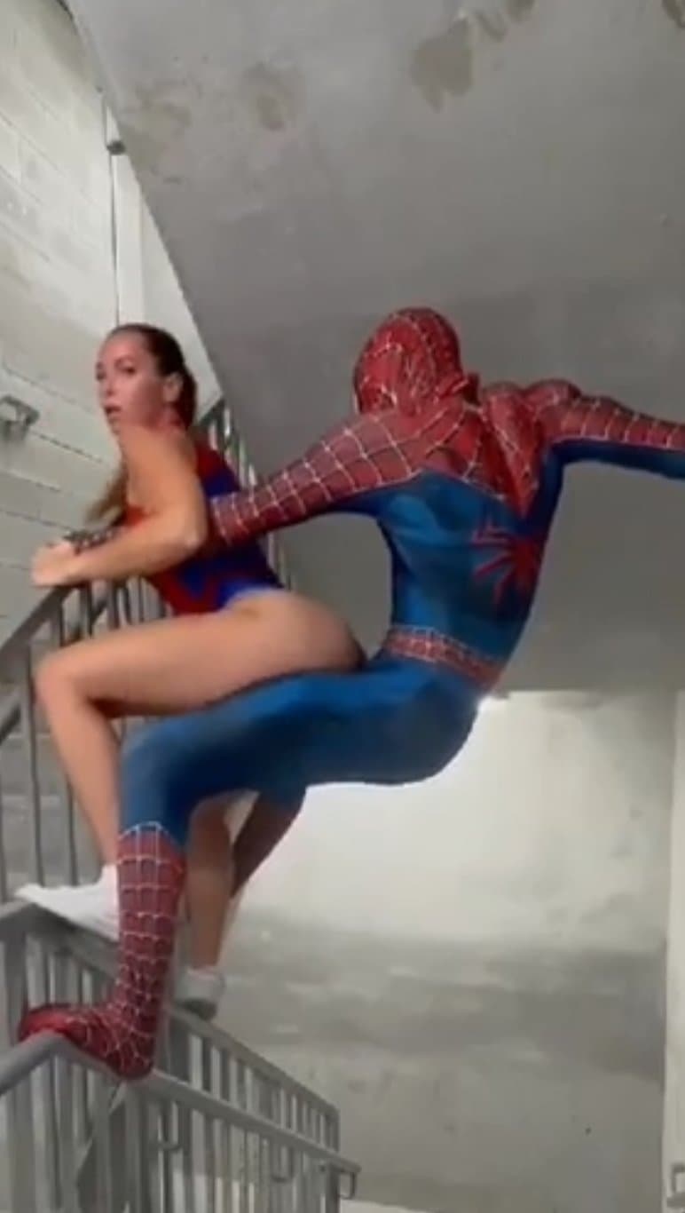 Spider-Man and spider woman having fun in the stairwell