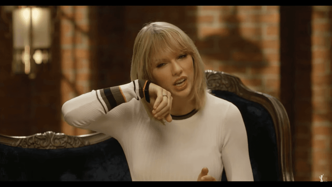 Taylor Swift tight white sweater, leather skirt, leather heels