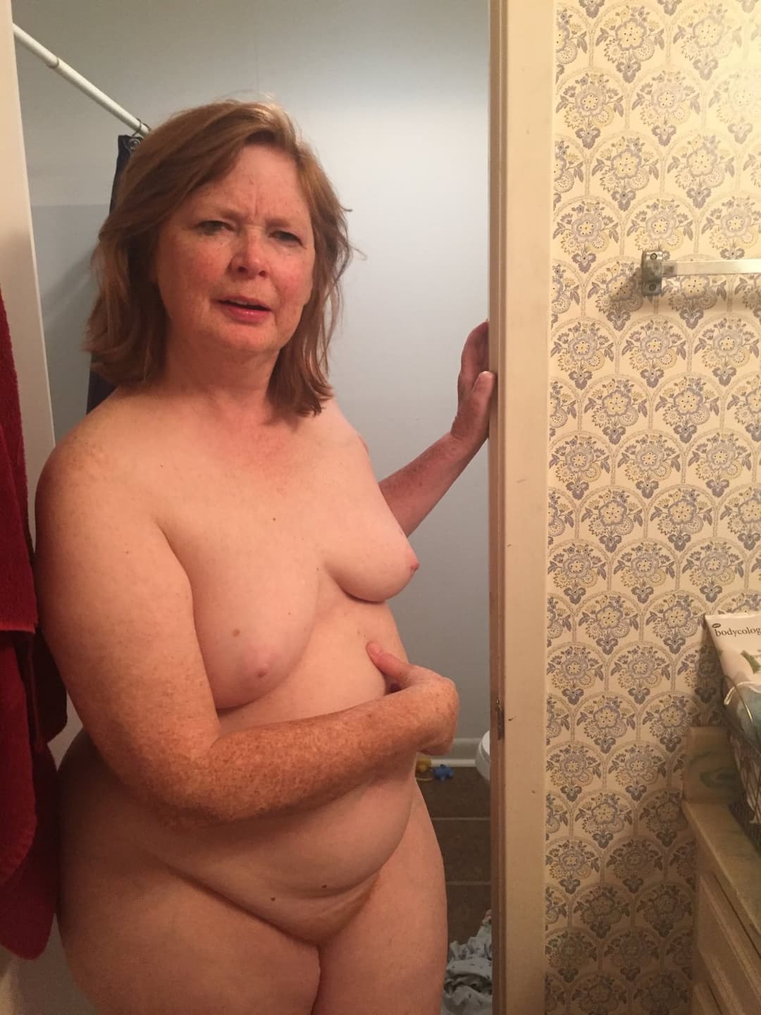A chubby mature woman likes to walk around the house naked.