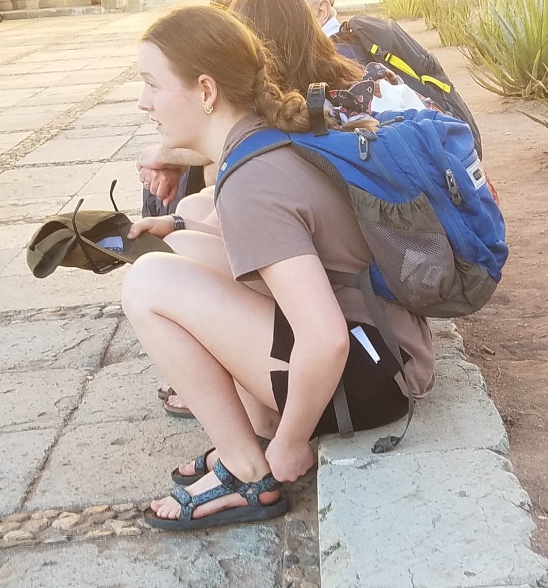 some girls sitting, showing legs and little else