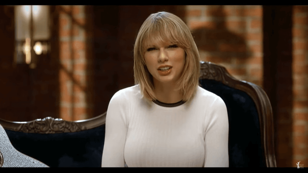 Taylor Swift tight white sweater, leather skirt, leather heels