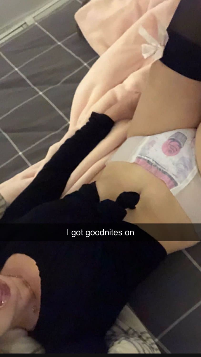 Cute tanned girl shows off her diapers and pull-ups