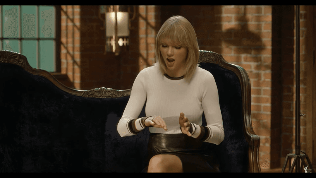 Taylor Swift tight white sweater, leather skirt, leather heels