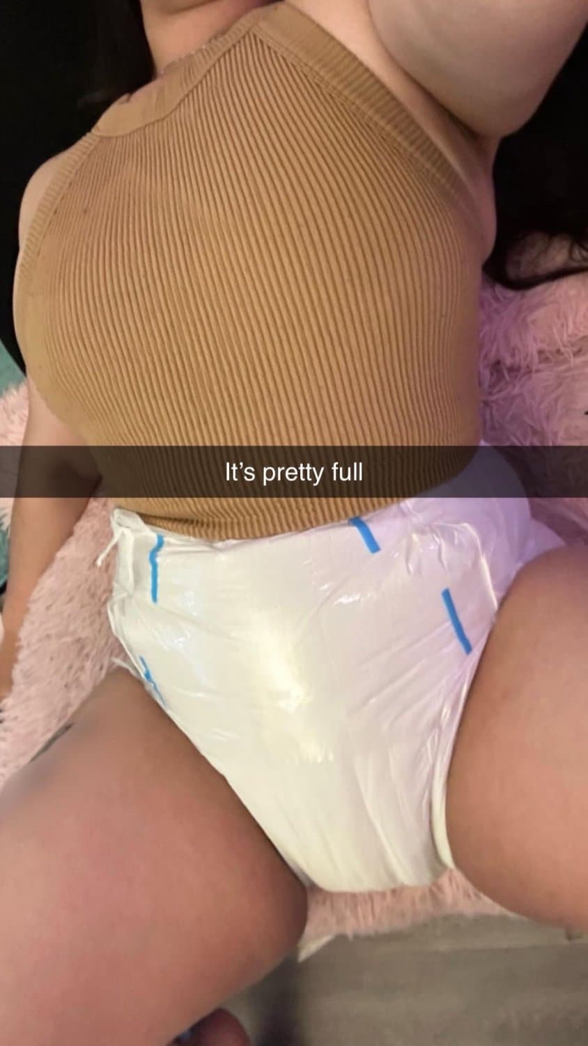 Click to view full size Incontinent college girl doesn’t mind showing off her diapers