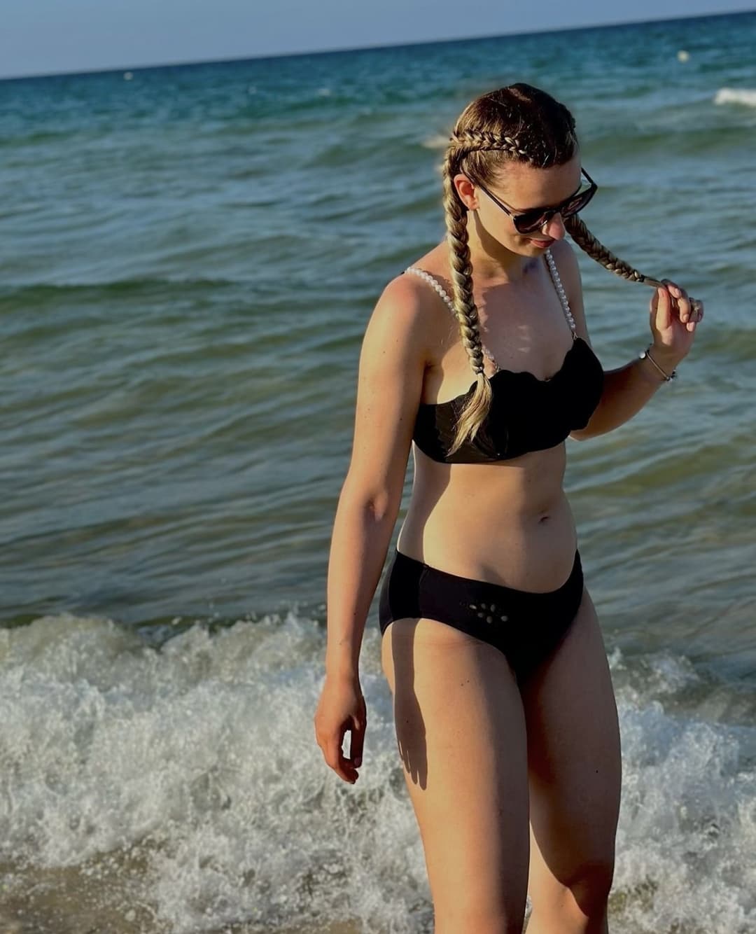 Cute little blonde Emilia Martis on the beach