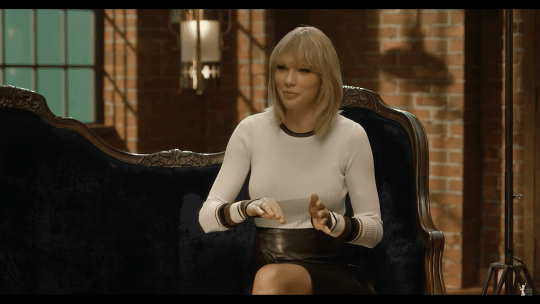 Taylor Swift tight white sweater, leather skirt, leather heels