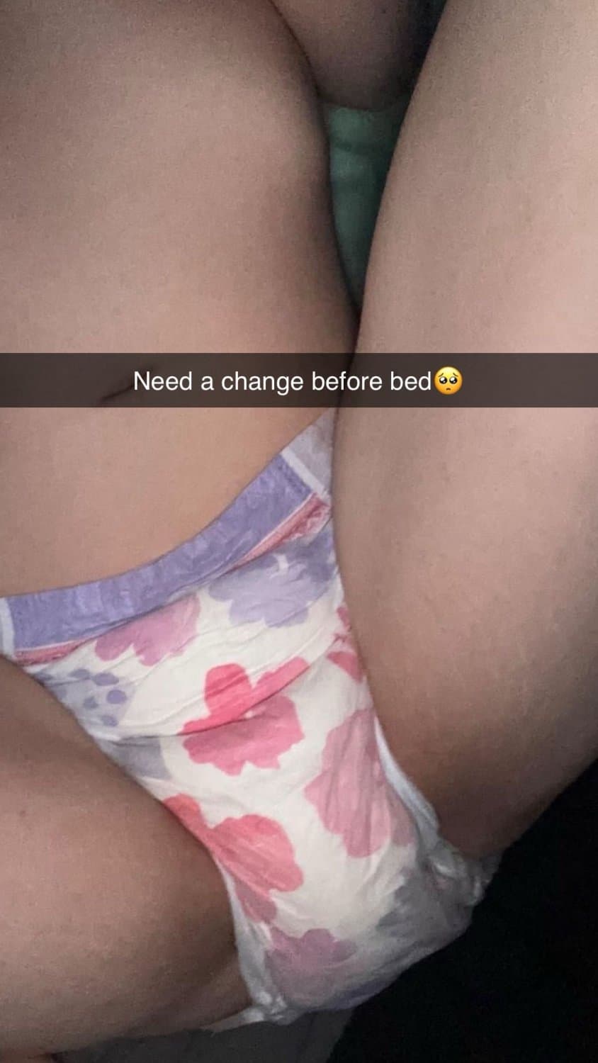 Cute tanned girl shows off her diapers and pull-ups