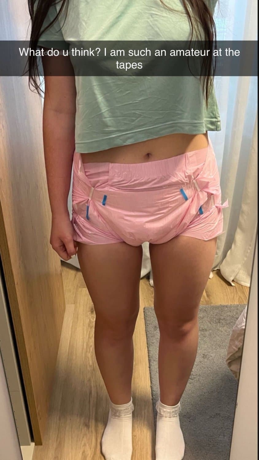 Cute tanned girl shows off her diapers and pull-ups