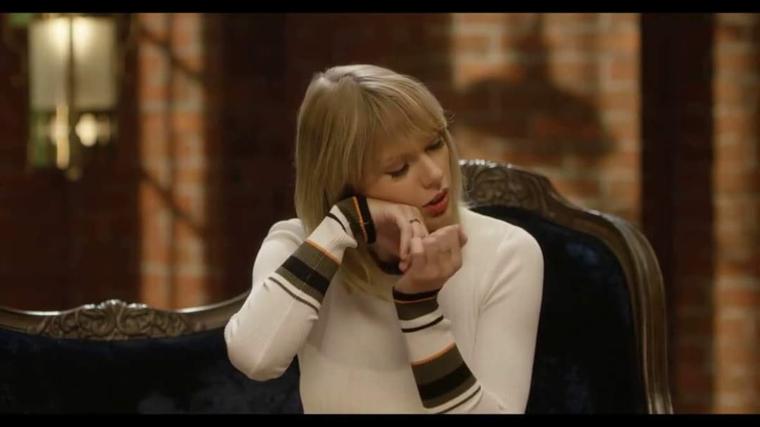 Taylor Swift tight white sweater, leather skirt, leather heels