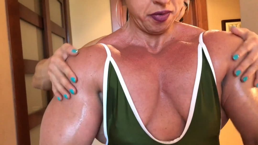 Click to view full size Mrs Bayres, hands on the enormous muscles of Mrs Sanchez