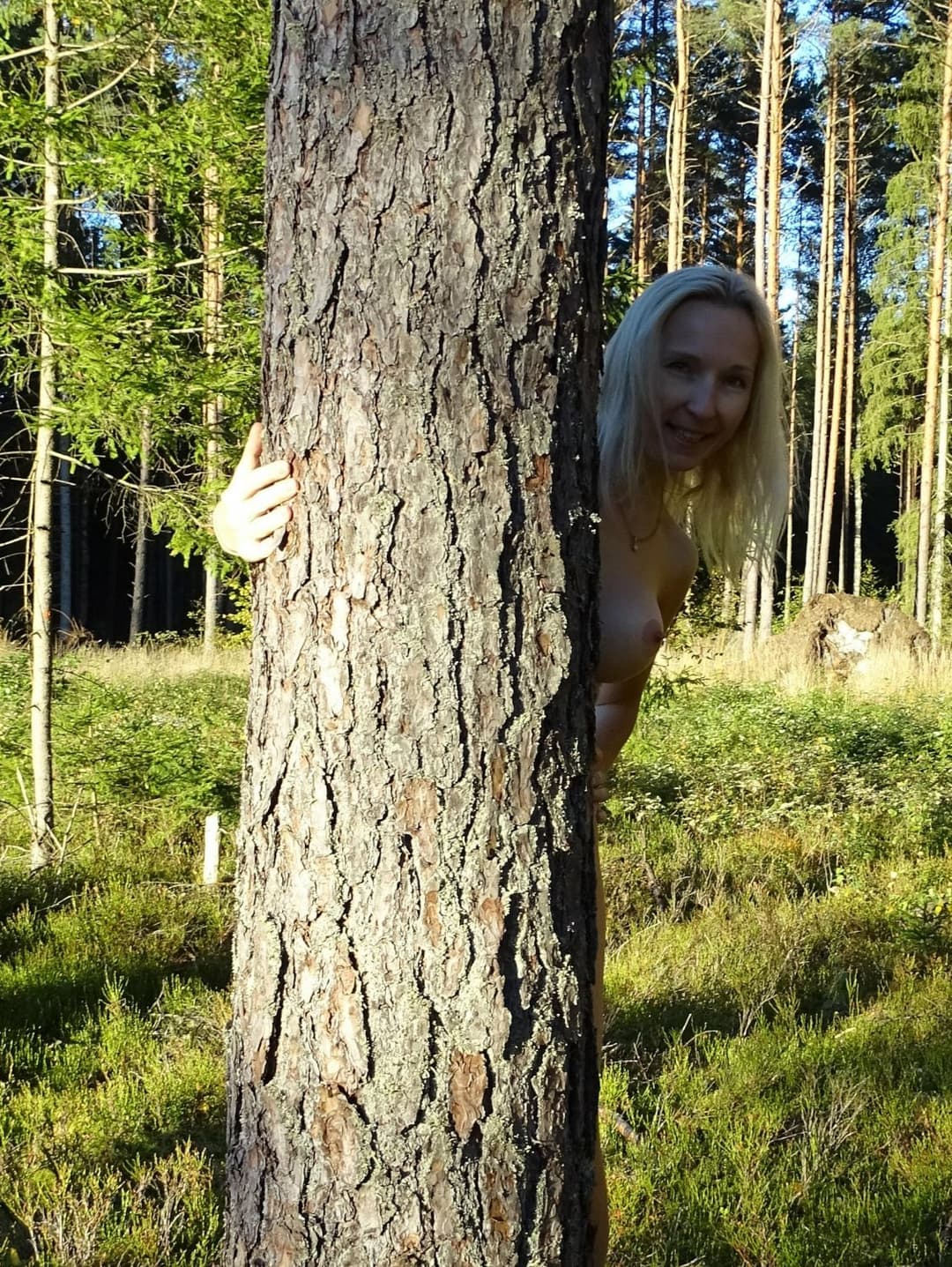 Amateur Skinny Blonde milf with fake tits shows herself in sunny forest outdoors. Buttplug in ass.