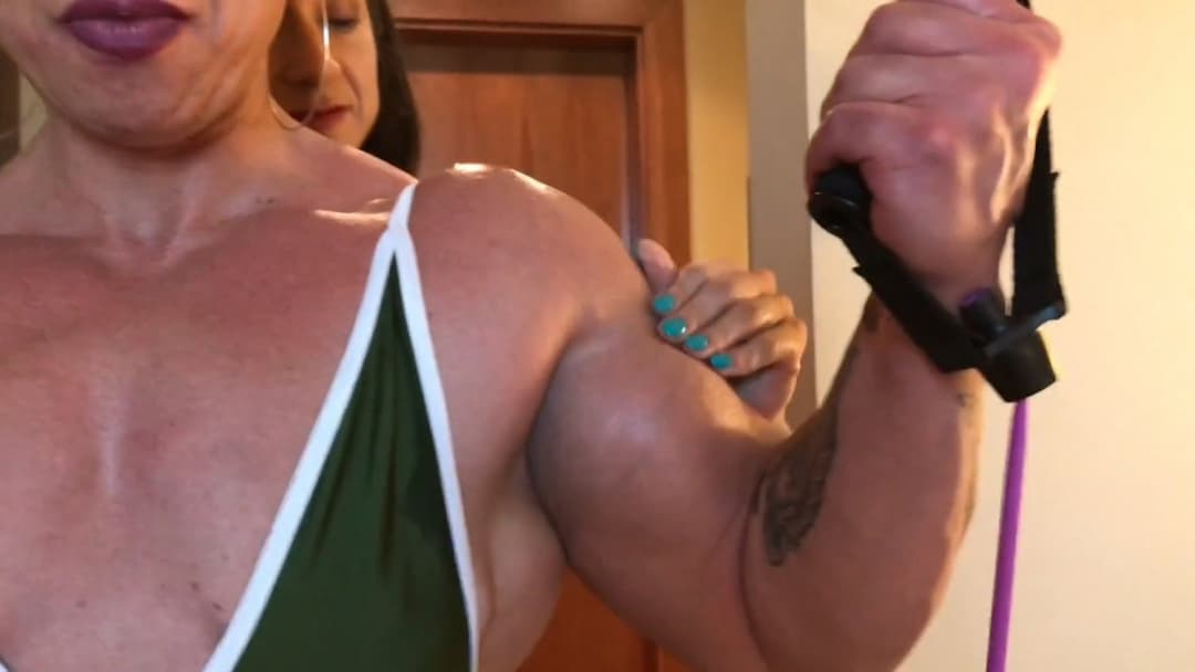 Click to view full size Mrs Bayres, hands on the enormous muscles of Mrs Sanchez